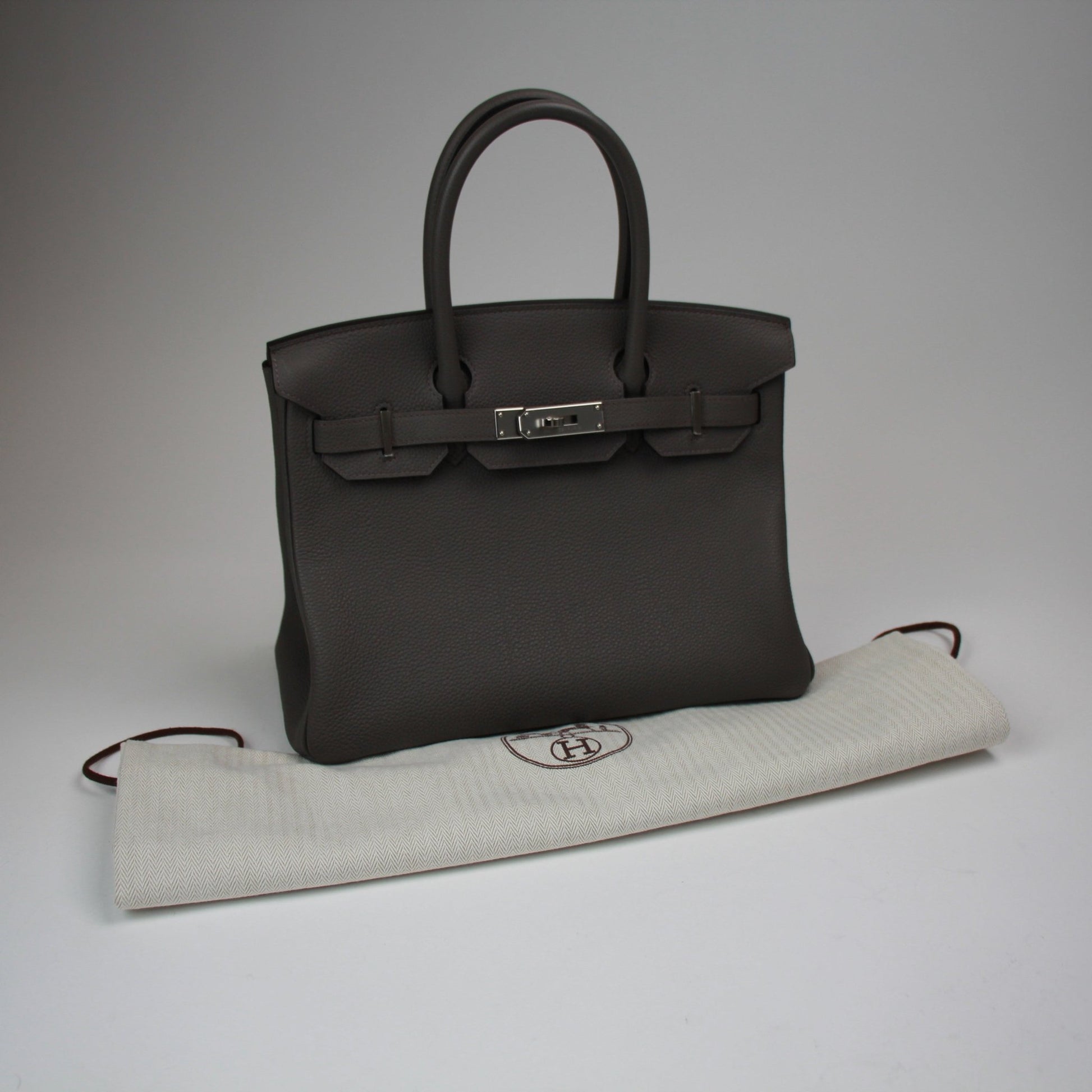Hermès Birkin 30 handbag in luxurious leather with gold hardware, showcased in a stylish and elegant design.