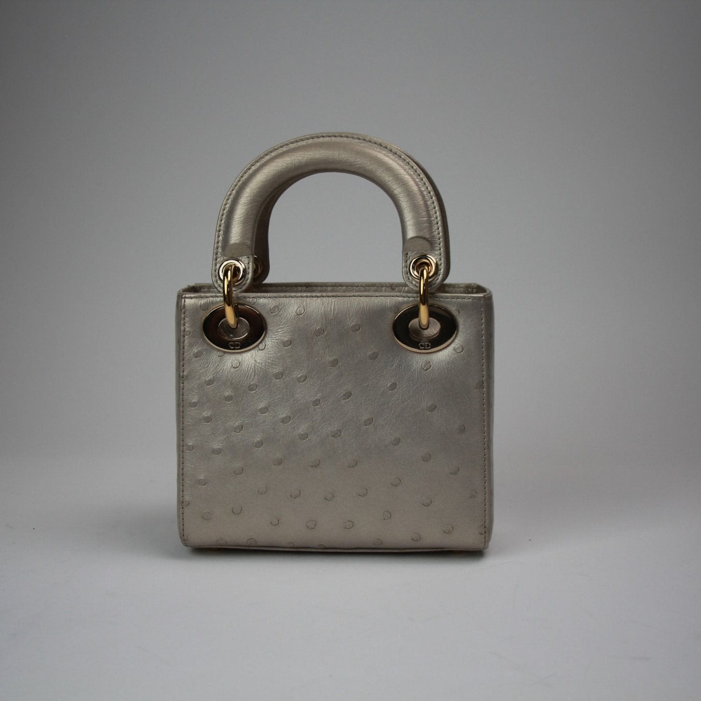 Gold & Beyond mini Lady Dior handbag, elegant Dior handbag with gold accents, featuring structured design and iconic style.