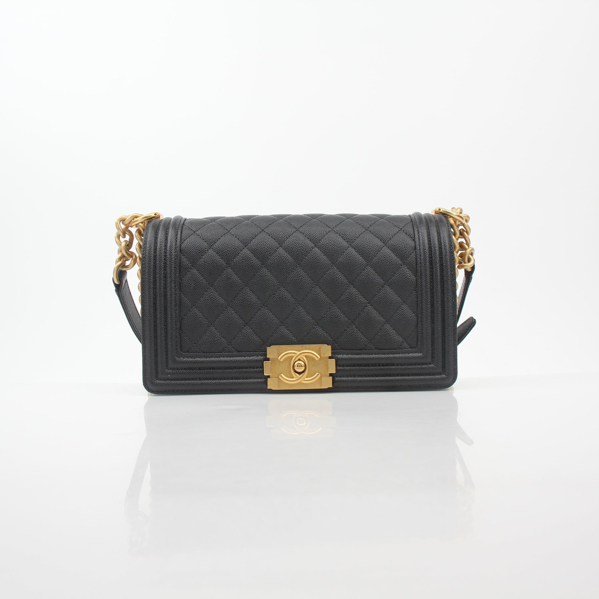 Black Chanel Caviar Boy Flap Shoulder Bag with gold hardware, featuring quilted leather and a chain strap.