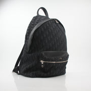 Black Dior Oblique Rider Backpack by Christian Dior, featuring logo pattern and leather accents, perfect for stylish travel and daily use.