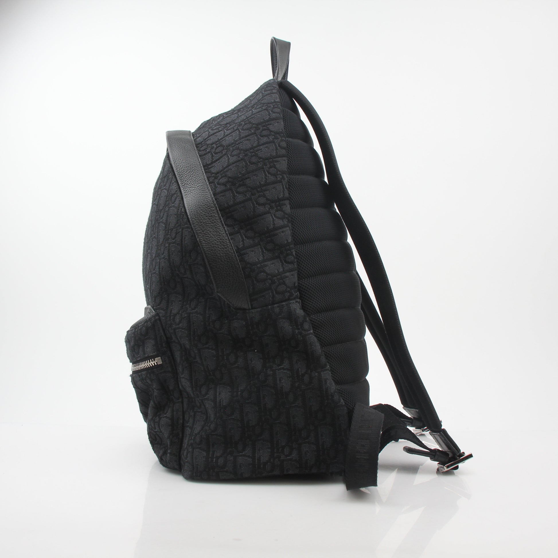 Black Christian Dior Dior Oblique Rider Backpack for travel, featuring signature Dior pattern and structured design.