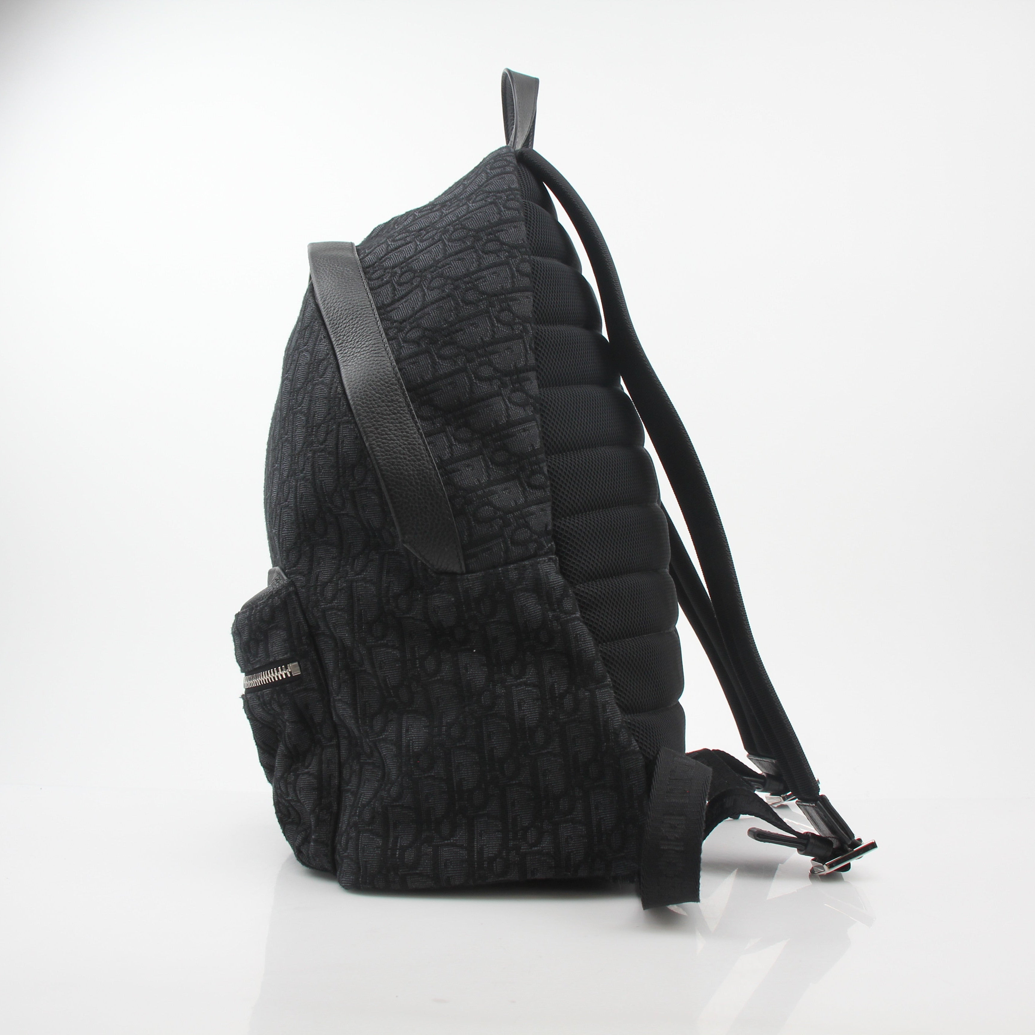 Black Christian Dior Dior Oblique Rider Backpack for travel, featuring signature Dior pattern and structured design.