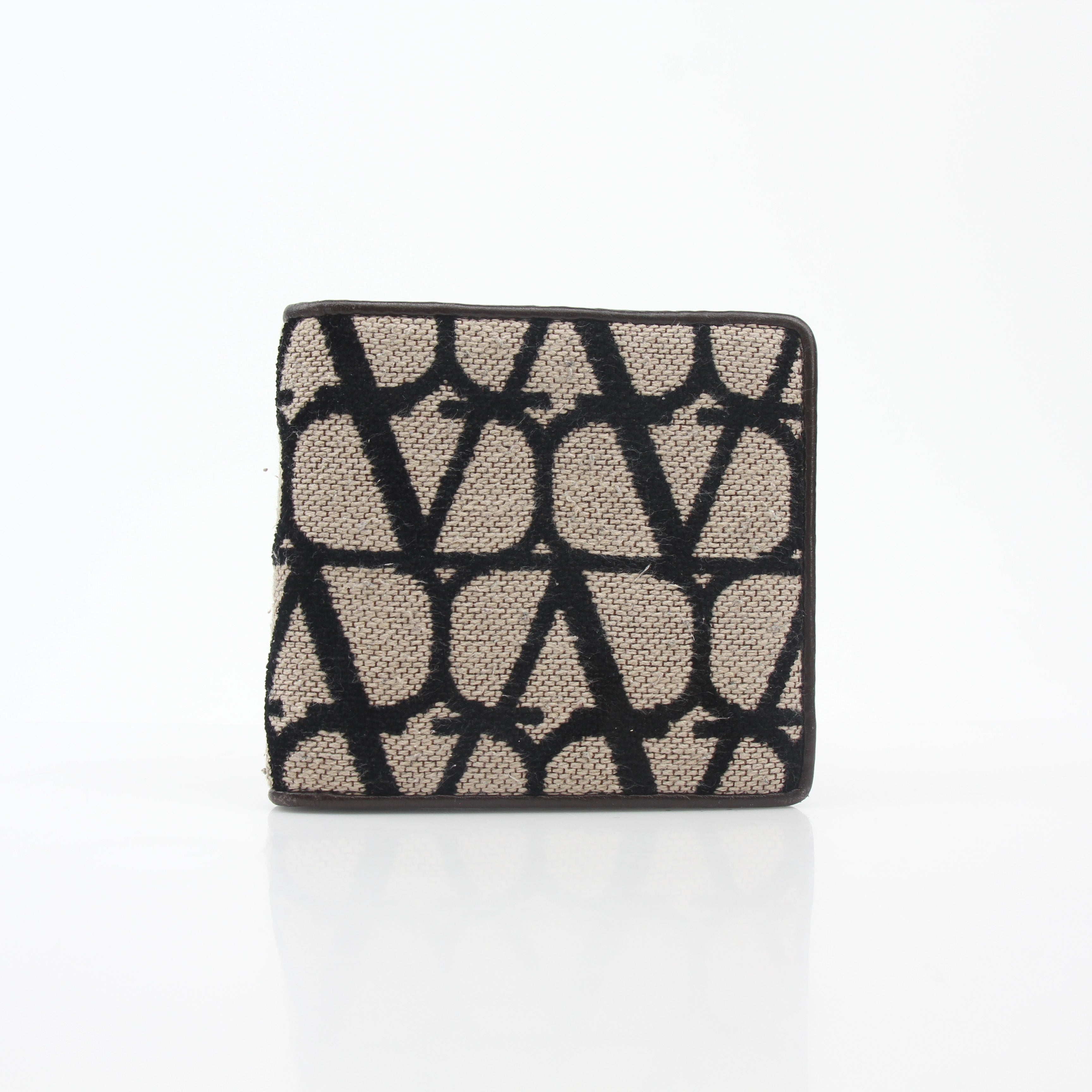 Valentino Garavani Toile Iconographe bifold wallet in natural and black leather with gold accents, showcasing detailed pattern and craftsmanship.