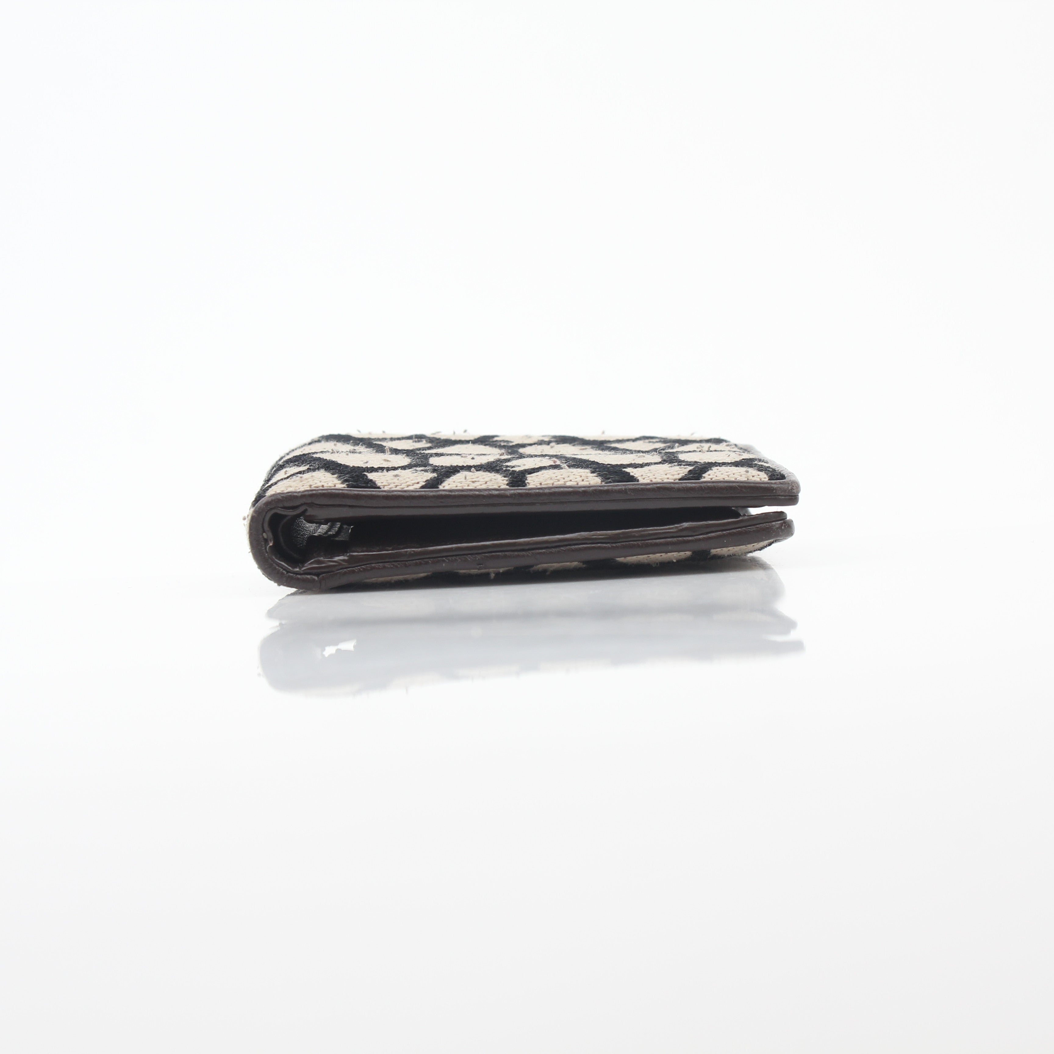 Valentino Garavani Toile Iconographe bifold wallet in natural and black leather with designer logo pattern.