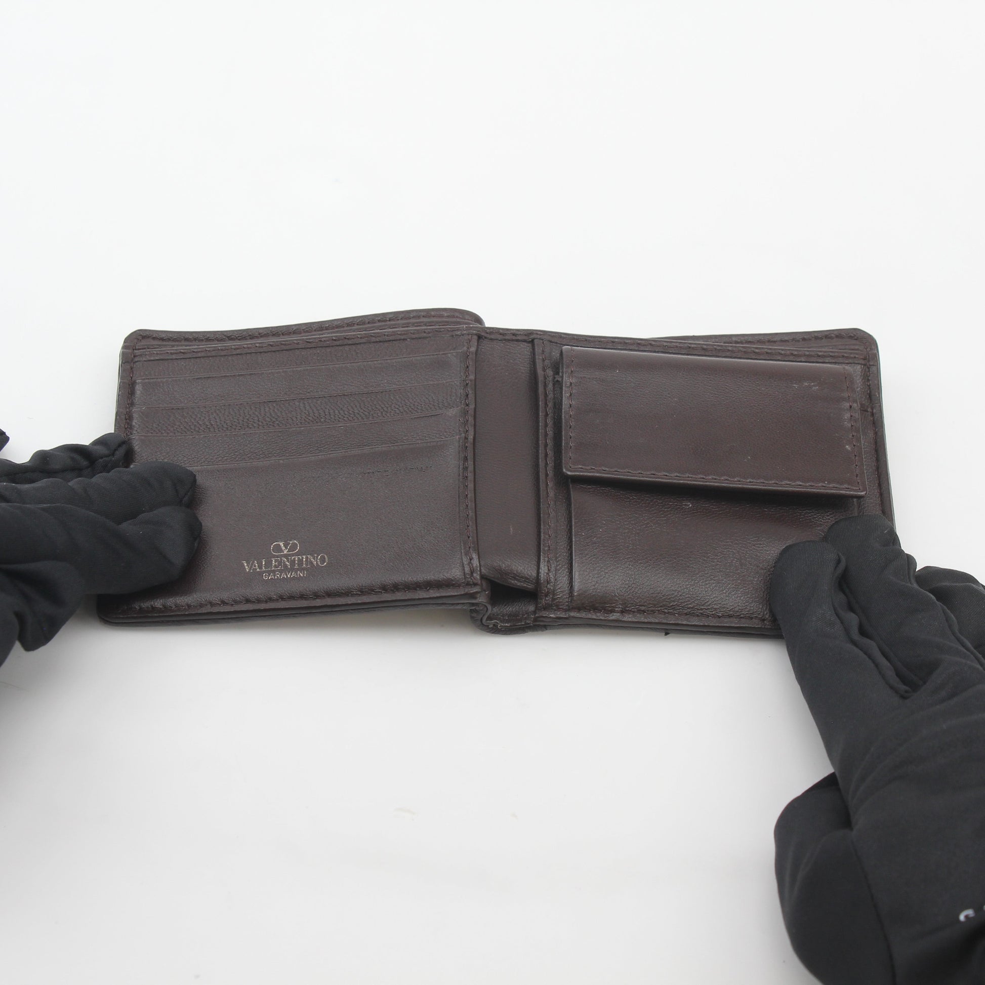 Valentino Garavani Toile Iconographe bifold wallet with natural and black leather, featuring signature design and branding.