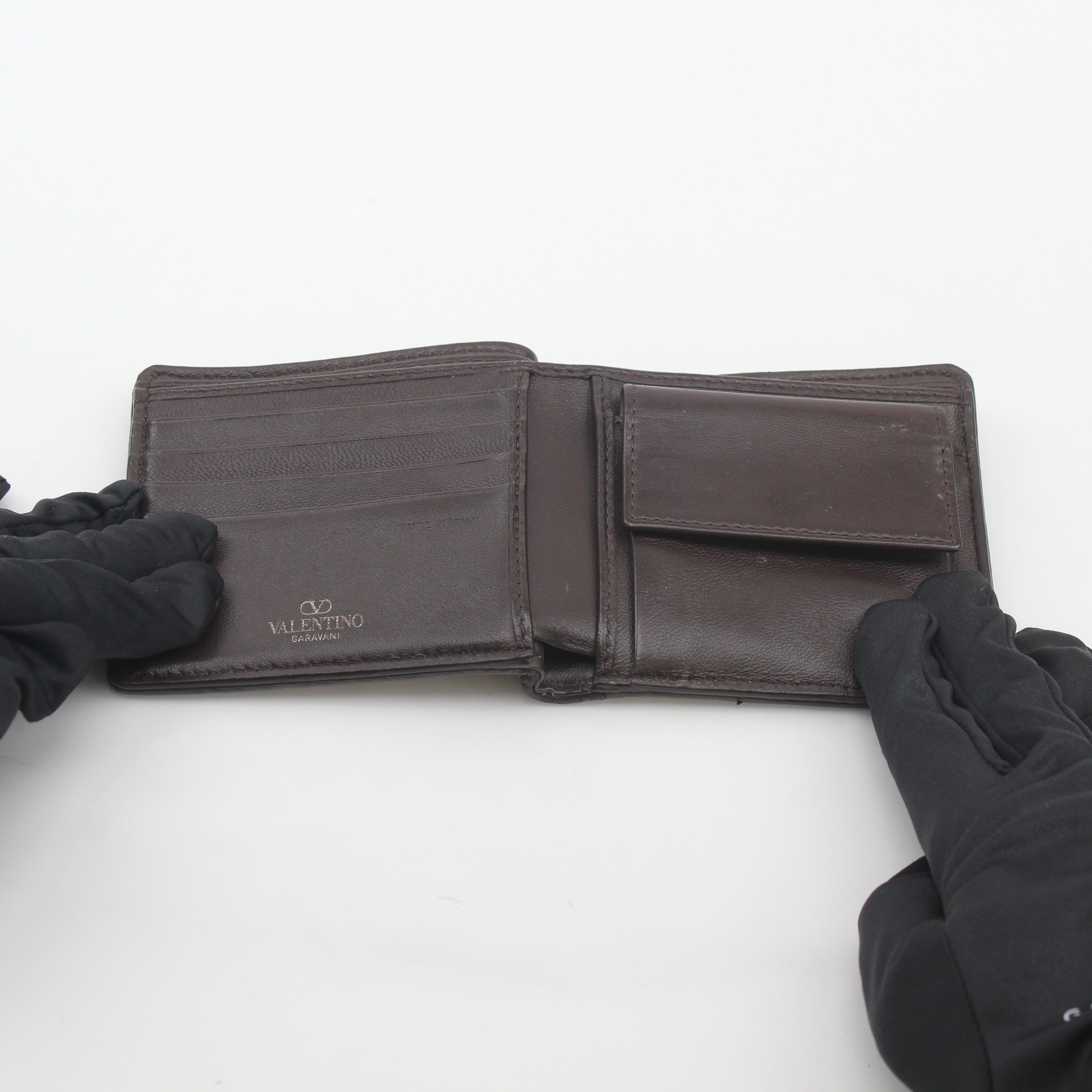 Valentino Garavani Toile Iconographe bifold wallet with natural and black leather, featuring signature design and branding.