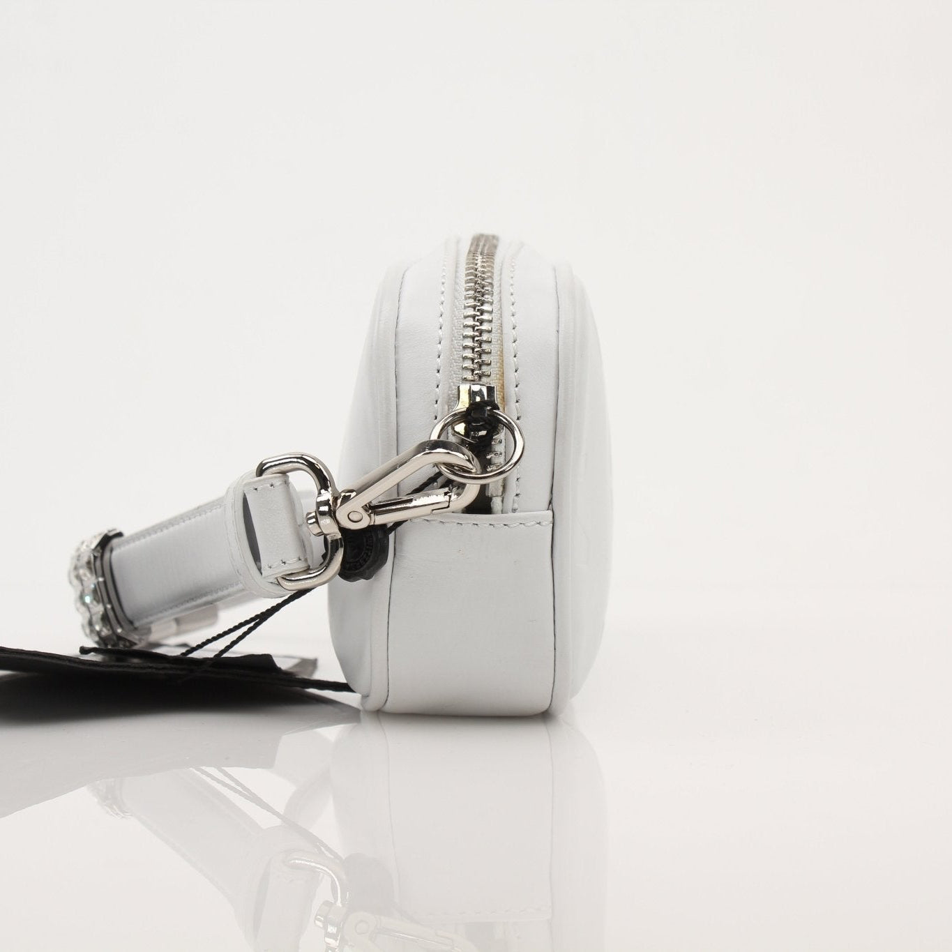 Gold and Beyond Philipp Plein shining clutch handbag with metallic finish and sleek design, resting on a neutral surface.