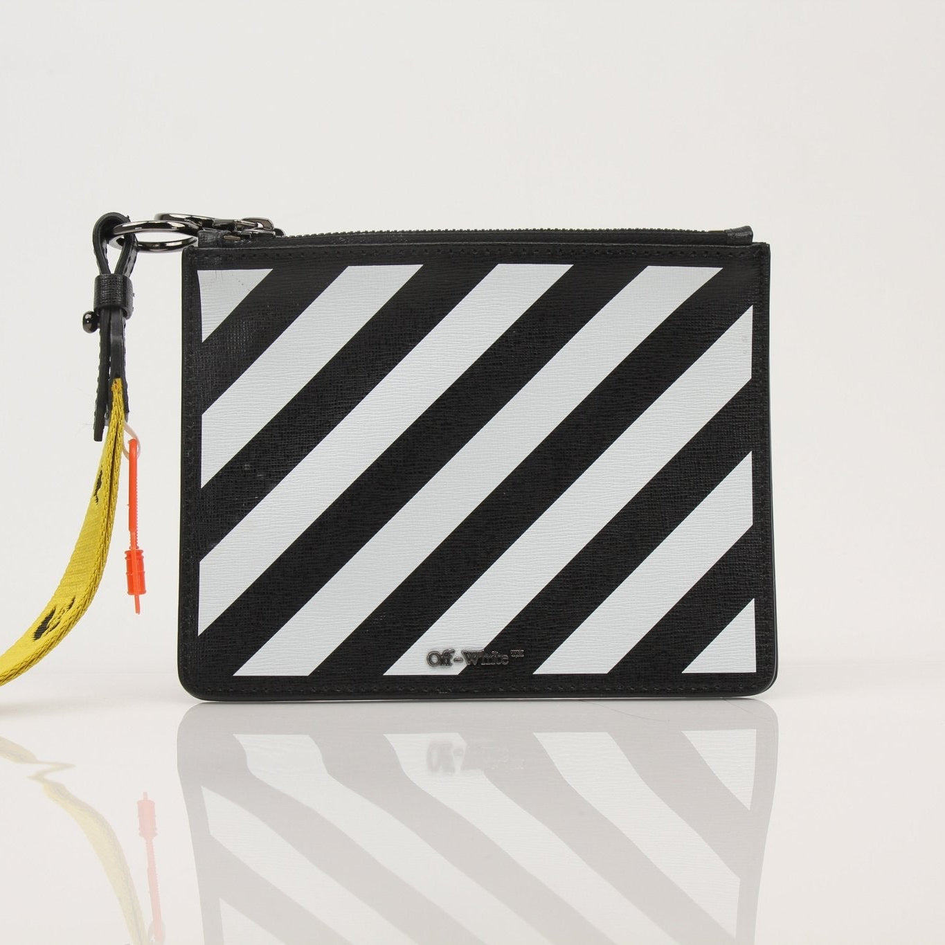 Off-White Diagonal Clutch handbag by Gold & Beyond, featuring signature diagonal pattern and sleek design, positioned on a neutral background.