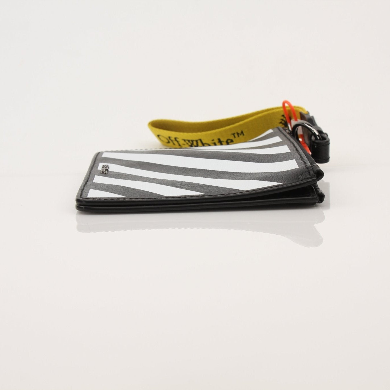 Gold & Beyond Off-White Diagonal Clutch handbag with signature striped design and sleek black leather accents.