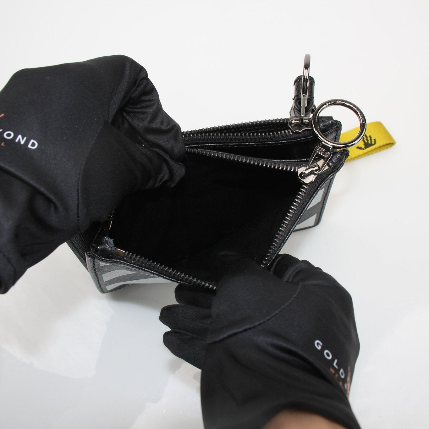 Off-White Diagonal Clutch handbag in black with signature diagonal stripe design, featuring a sleek, compact style.