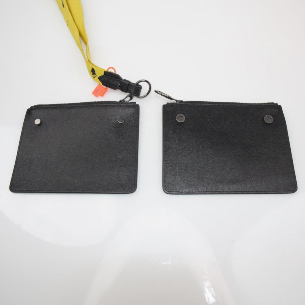Off-White Diagonal Clutch handbag by Gold & Beyond with signature diagonal design and sleek black finish.