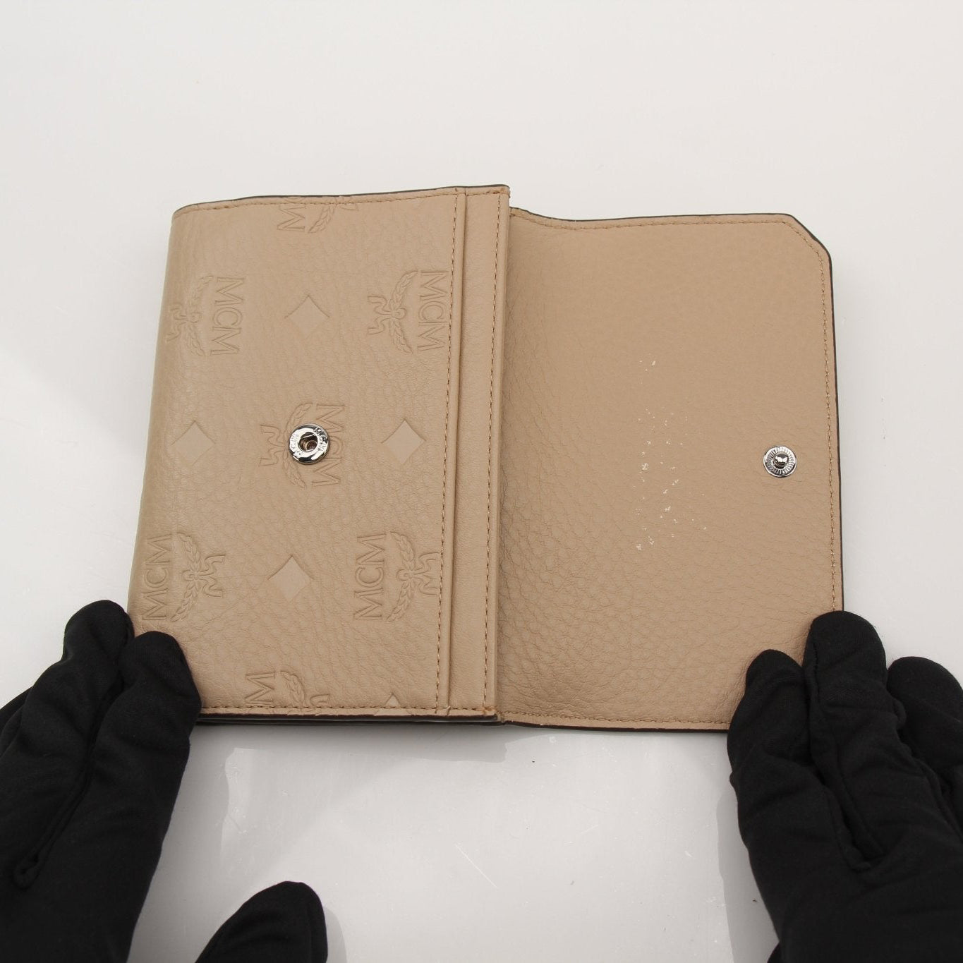 Gold & Beyond MCM trifold beige wallet with multiple card slots and a sleek design for everyday use.