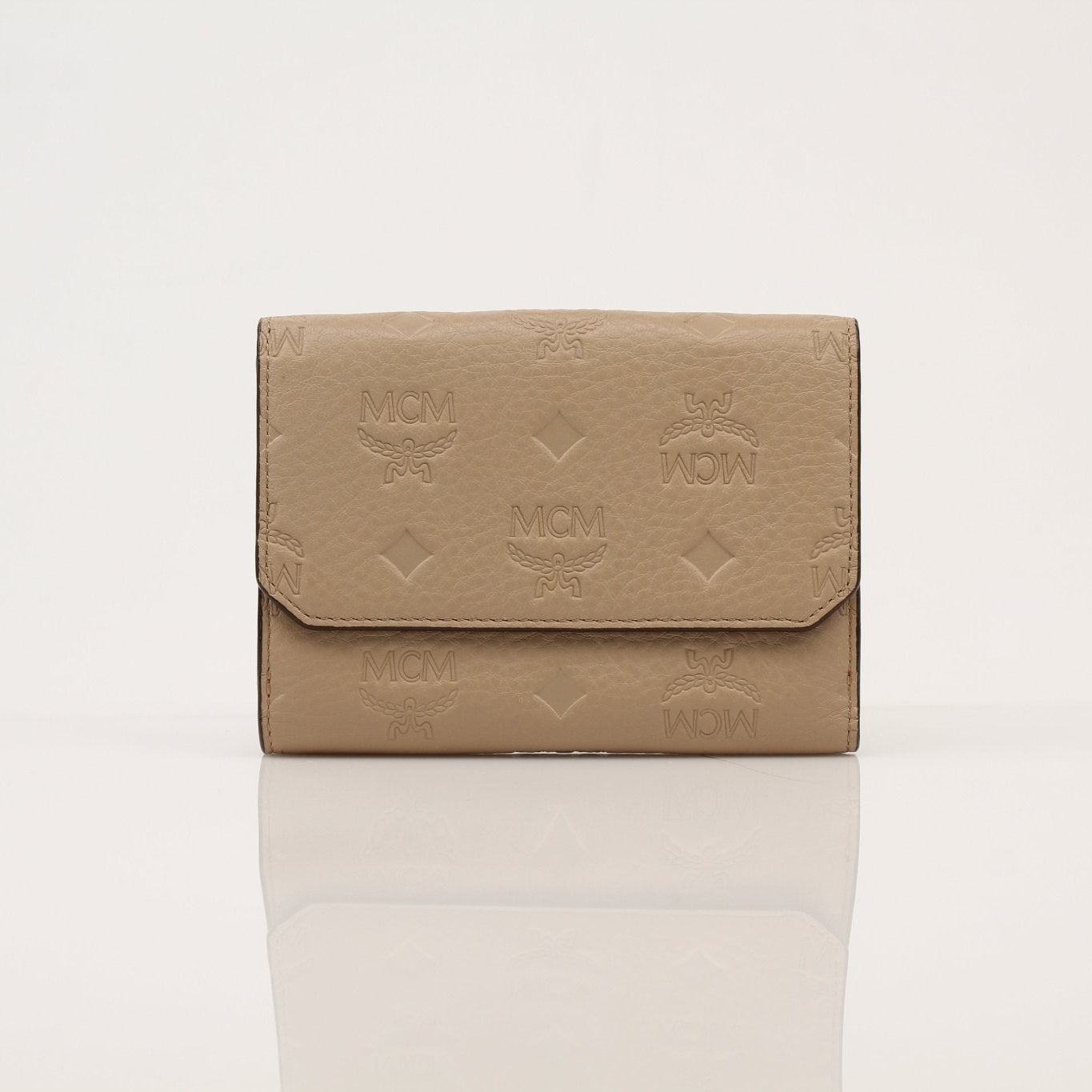 Beige MCM trifold wallet by Gold & Beyond with multiple card slots and a sleek, compact design.