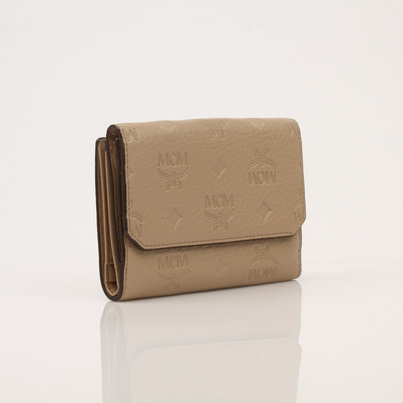 Beige MCM trifold wallet by Gold & Beyond with multiple card slots and a sleek, compact design.