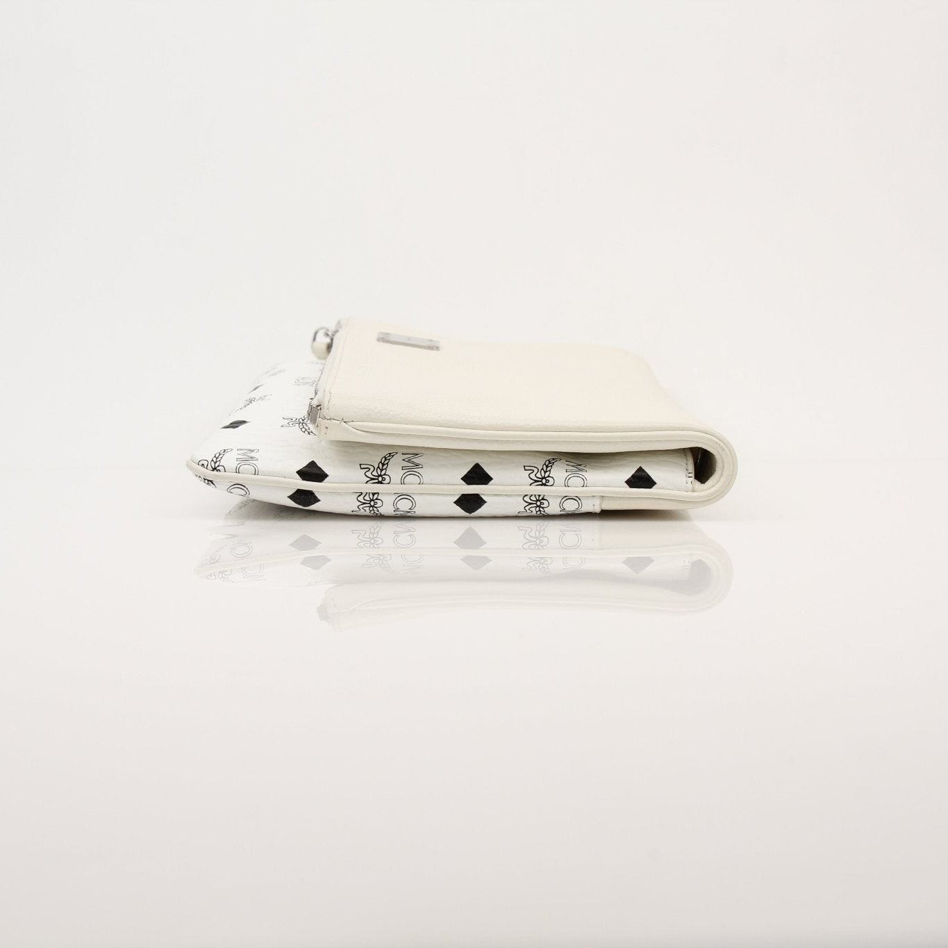 Gold & Beyond MCM fold-over crossbody pouch handbag with sleek design and compact style, shown in the image.