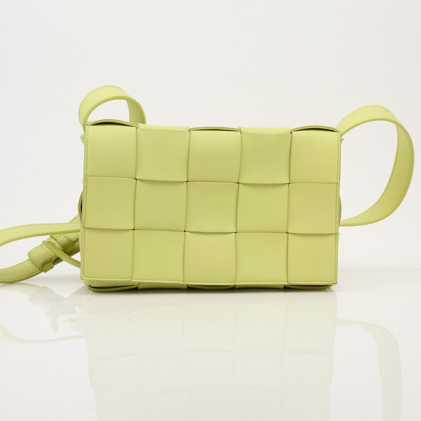 Gold & Beyond Bottega Veneta Kiwi Cassette crossbody handbag with woven leather design and adjustable strap.