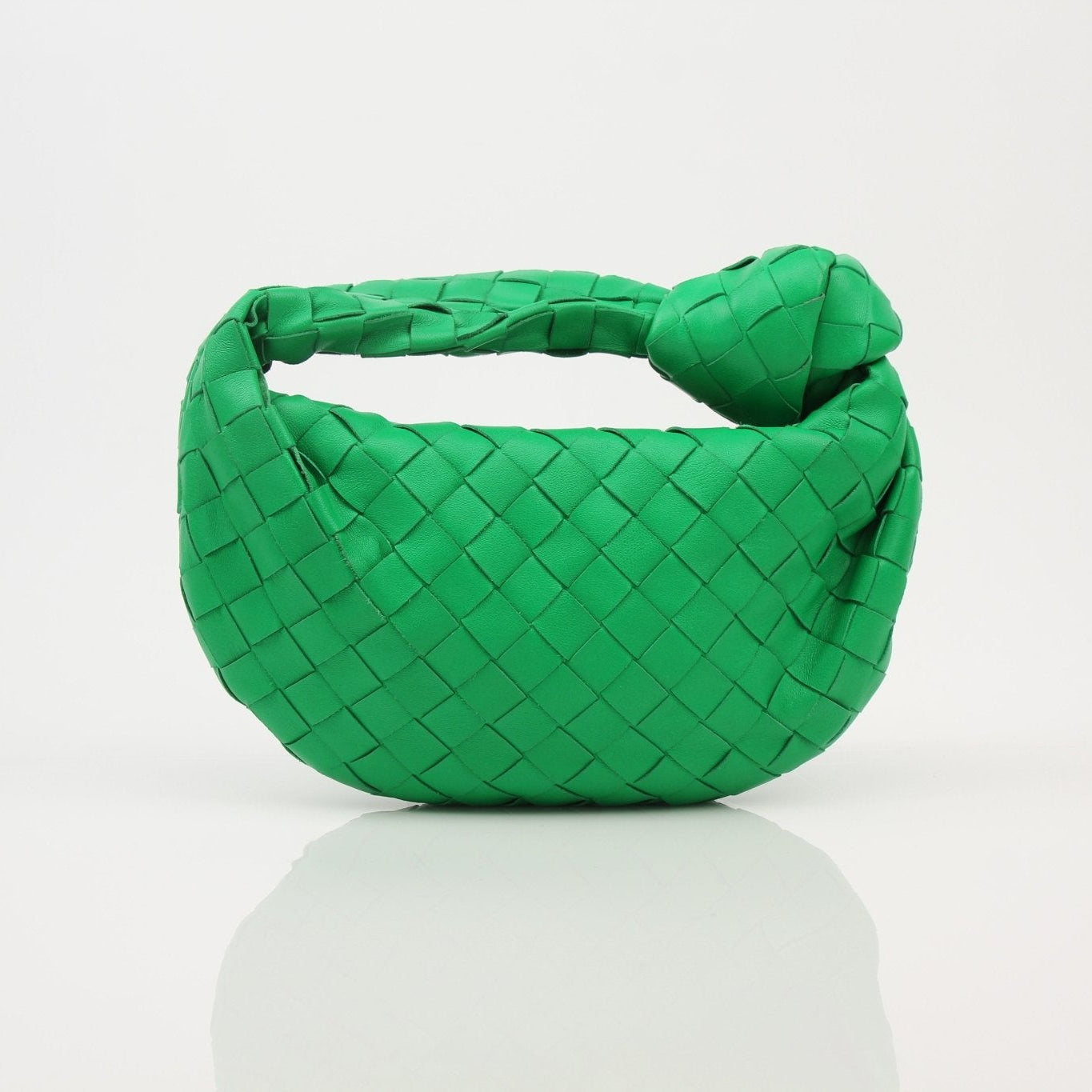 Bottega Veneta Mini Jodie Bag in soft leather, showcasing its unique woven design and compact size for stylish carry.