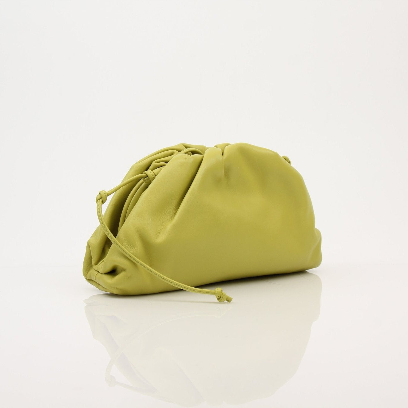Green Bottega Veneta The Pouch Mini handbag with gold accents, stylishly displayed with a soft leather texture.