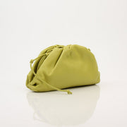 Green Bottega Veneta The Pouch Mini handbag with gold accents, stylishly displayed with a soft leather texture.