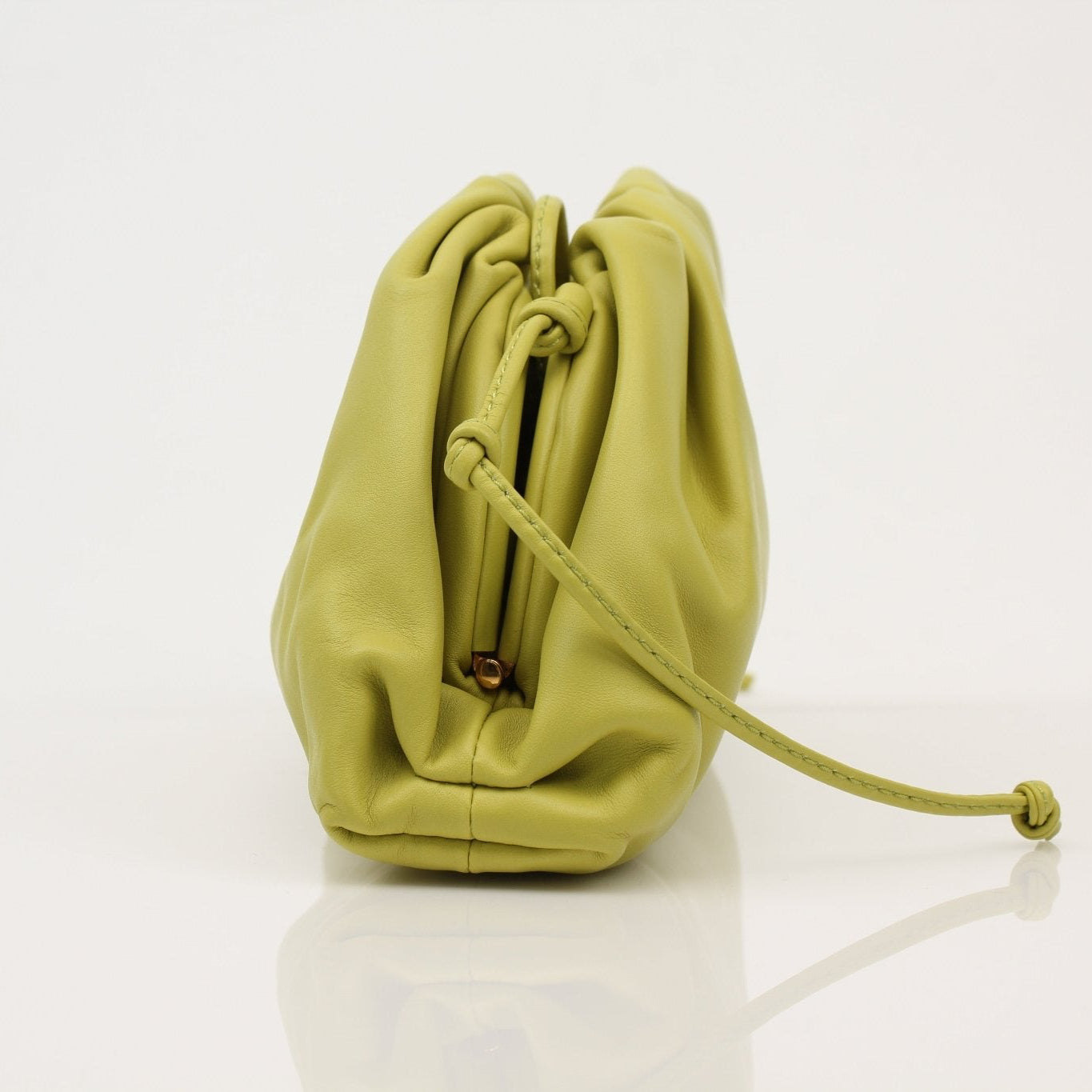 Gold & Beyond green Bottega Veneta The Pouch Mini handbag with woven leather detail on a white background.