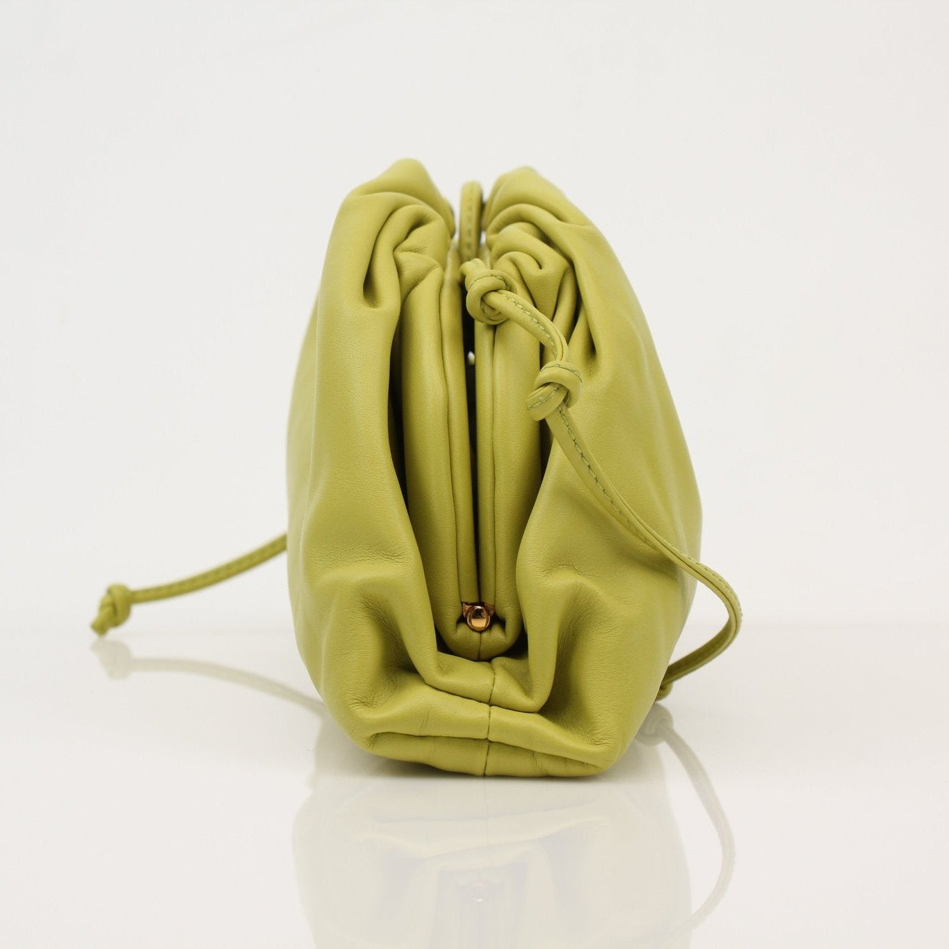 Green Bottega Veneta The Pouch Mini handbag with sleek design, featuring the signature woven leather style.