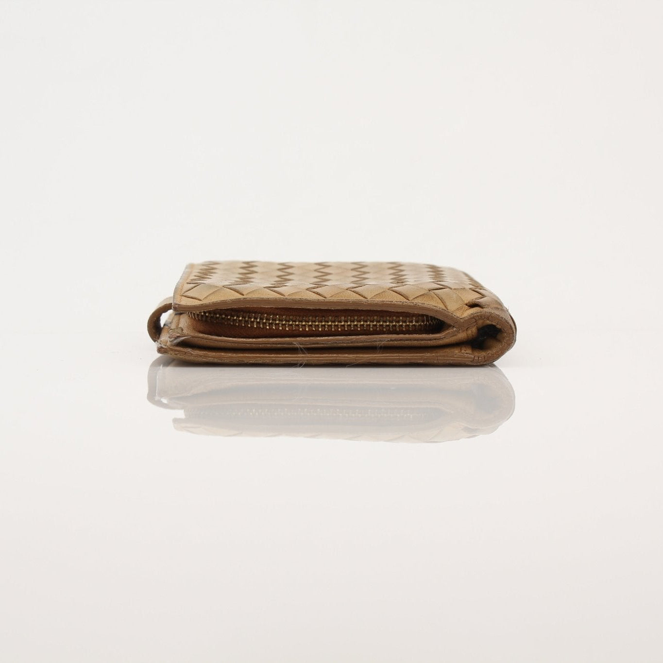 Bottega Veneta Vintage Intrecciato leather wallet with woven design, shown in a close-up image.