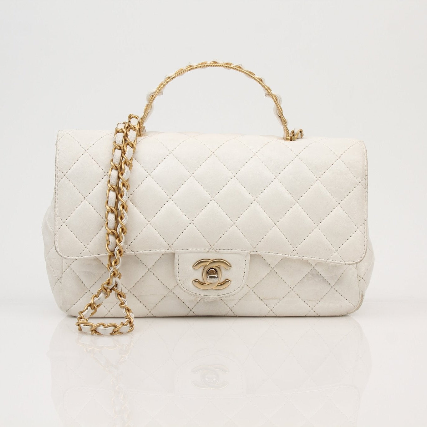 Gold & Beyond Chanel Lambskin Top Handle Bag, elegant black handbag with gold hardware and structured design.