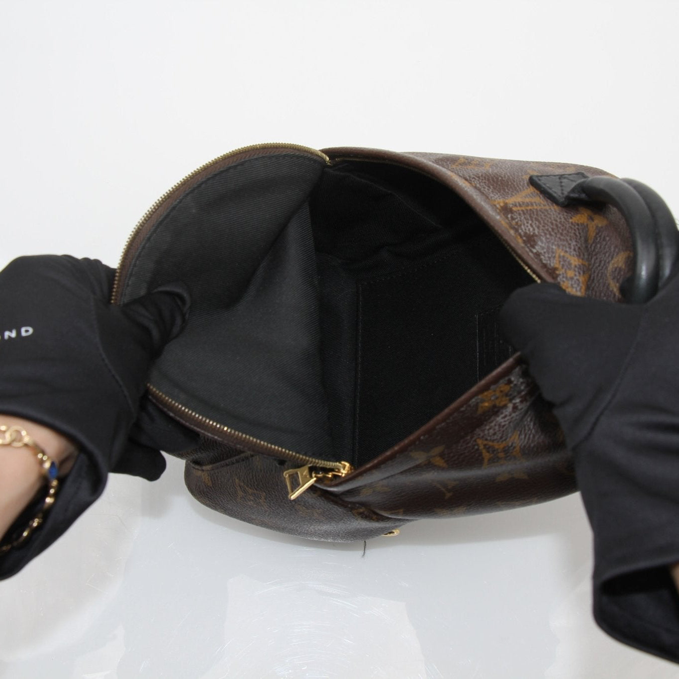Gold & Beyond Louis Vuitton Palm Springs Mini Backpack handbag with monogram canvas and adjustable straps.