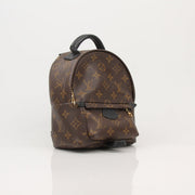 Gold & Beyond Louis Vuitton Palm Springs Mini Backpack handbag with patterned fabric and adjustable straps, front zip pocket.