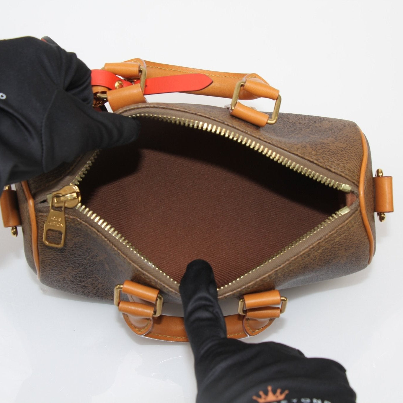 Louis Vuitton Keepall 25 Monogram Canvas Bag, a luxury handbag with iconic monogram design and sturdy handles.