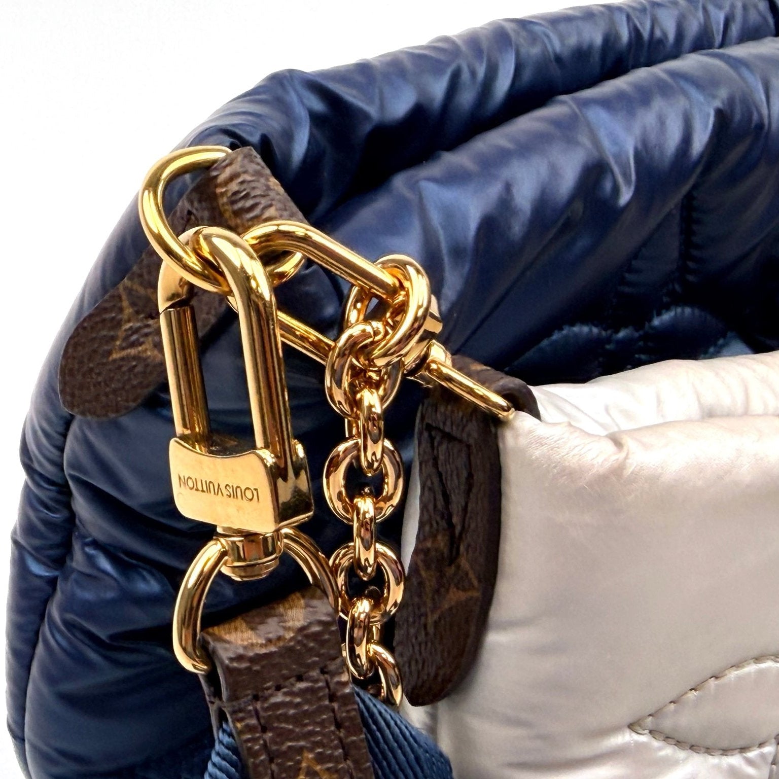 Louis Vuitton Pillow Multi Pochette handbag with gold accents, featuring a soft, padded design and multiple compartments.