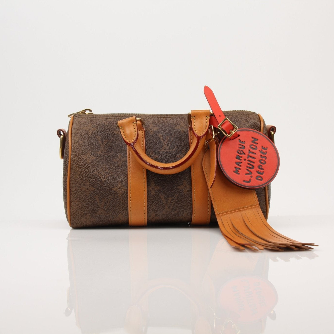 Louis Vuitton Keepall 25 Monogram Canvas Bag, gold hardware, adjustable leather strap, and classic monogram print.