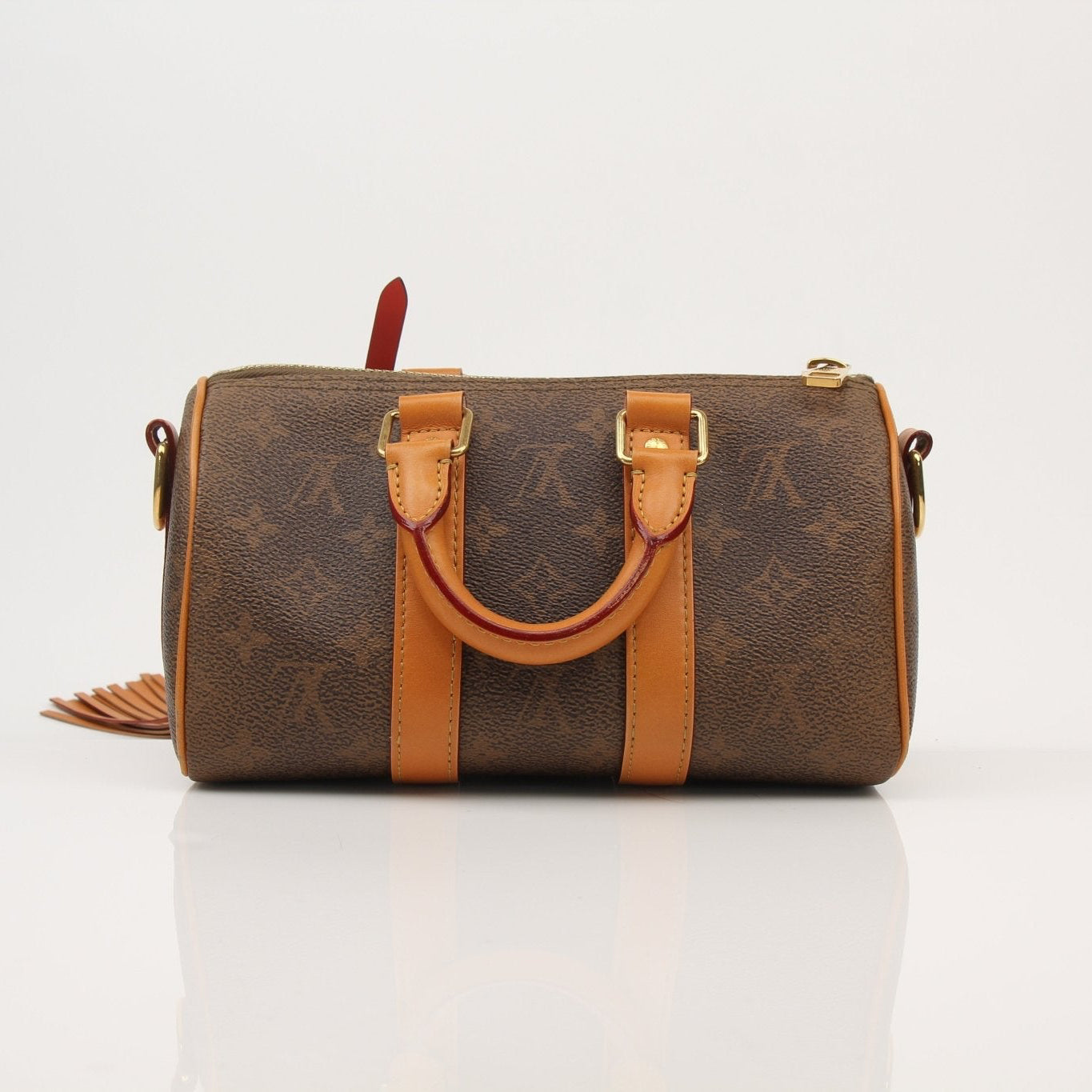 Louis Vuitton Keepall 25 Monogram Canvas Bag, luxury designer handbag with natural wear and gold-tone hardware, on a plain background.
