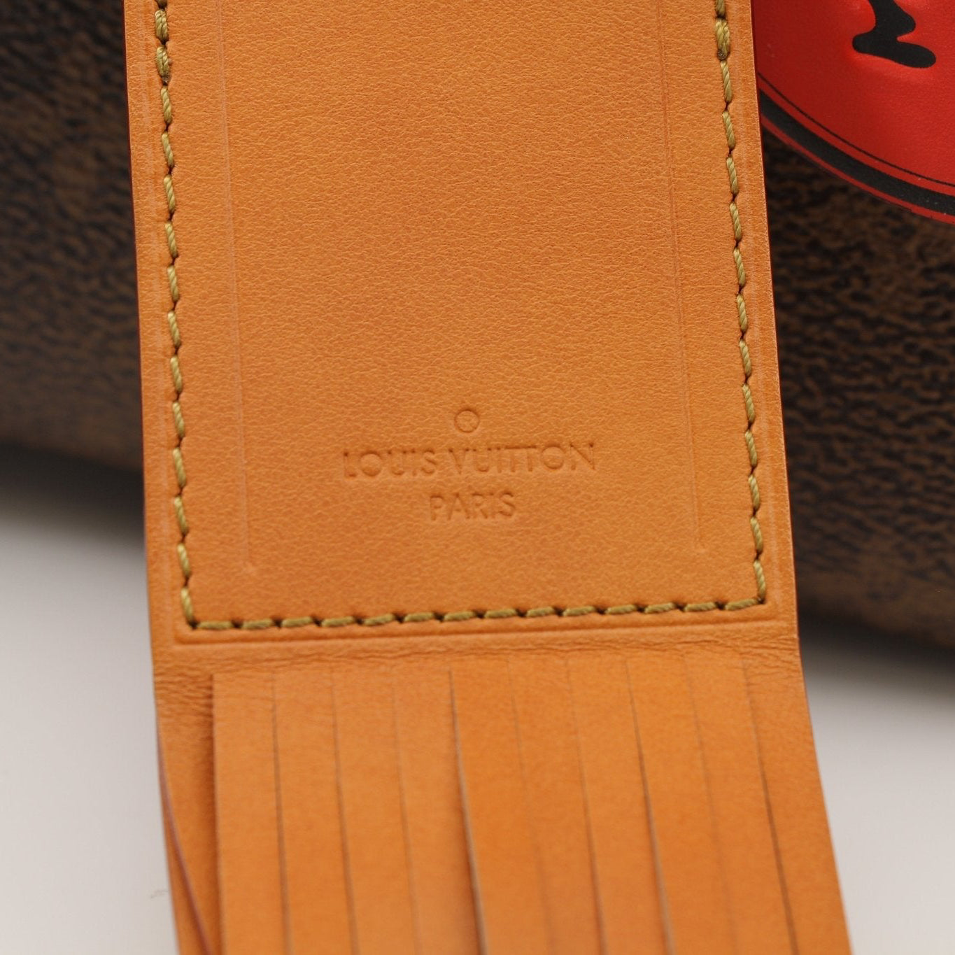 Louis Vuitton Keepall 25 Monogram Canvas handbag with leather handles and gold-tone hardware on a neutral background.