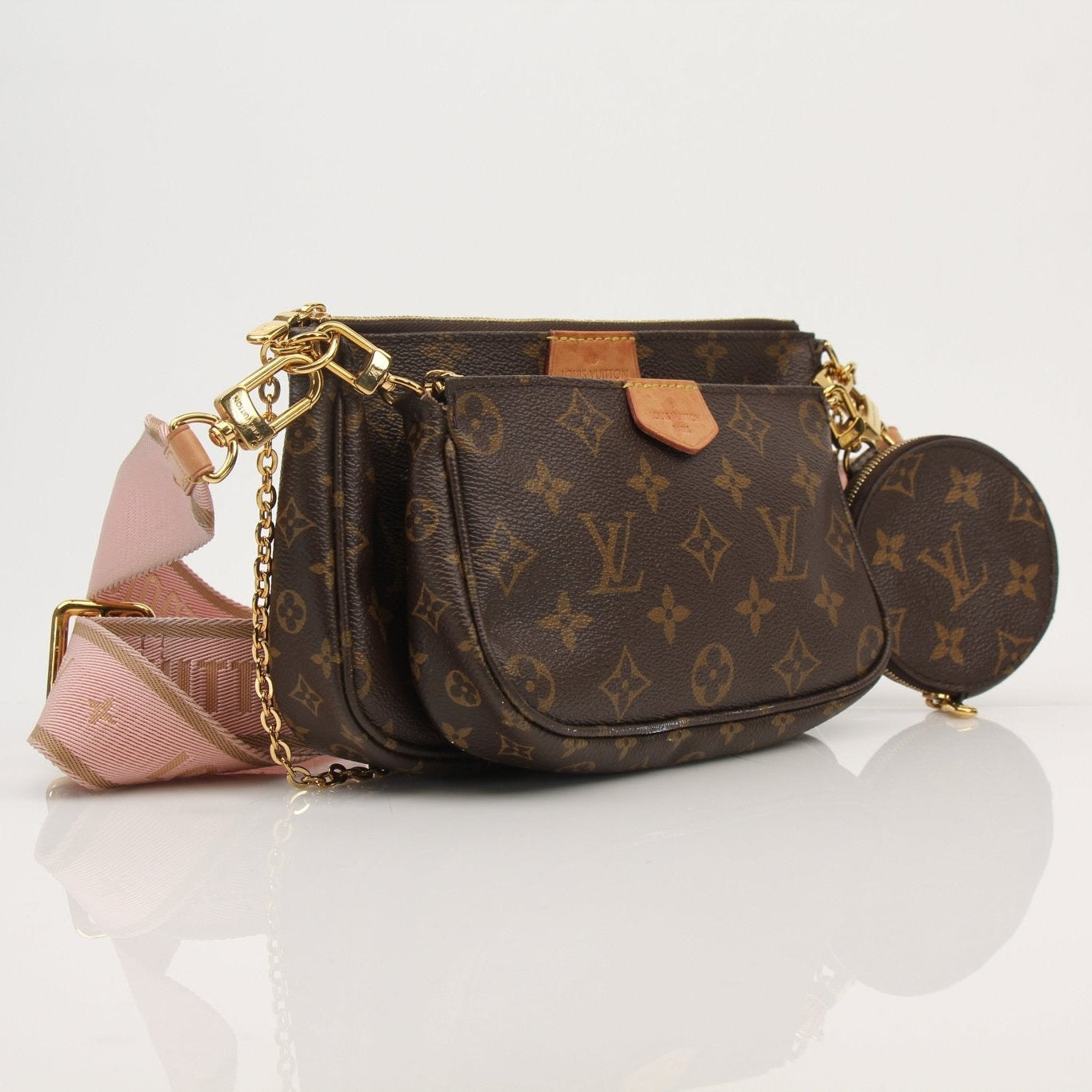 Louis Vuitton Multi Pochette handbag with gold-tone accents, featuring multiple compartments and stylish design.