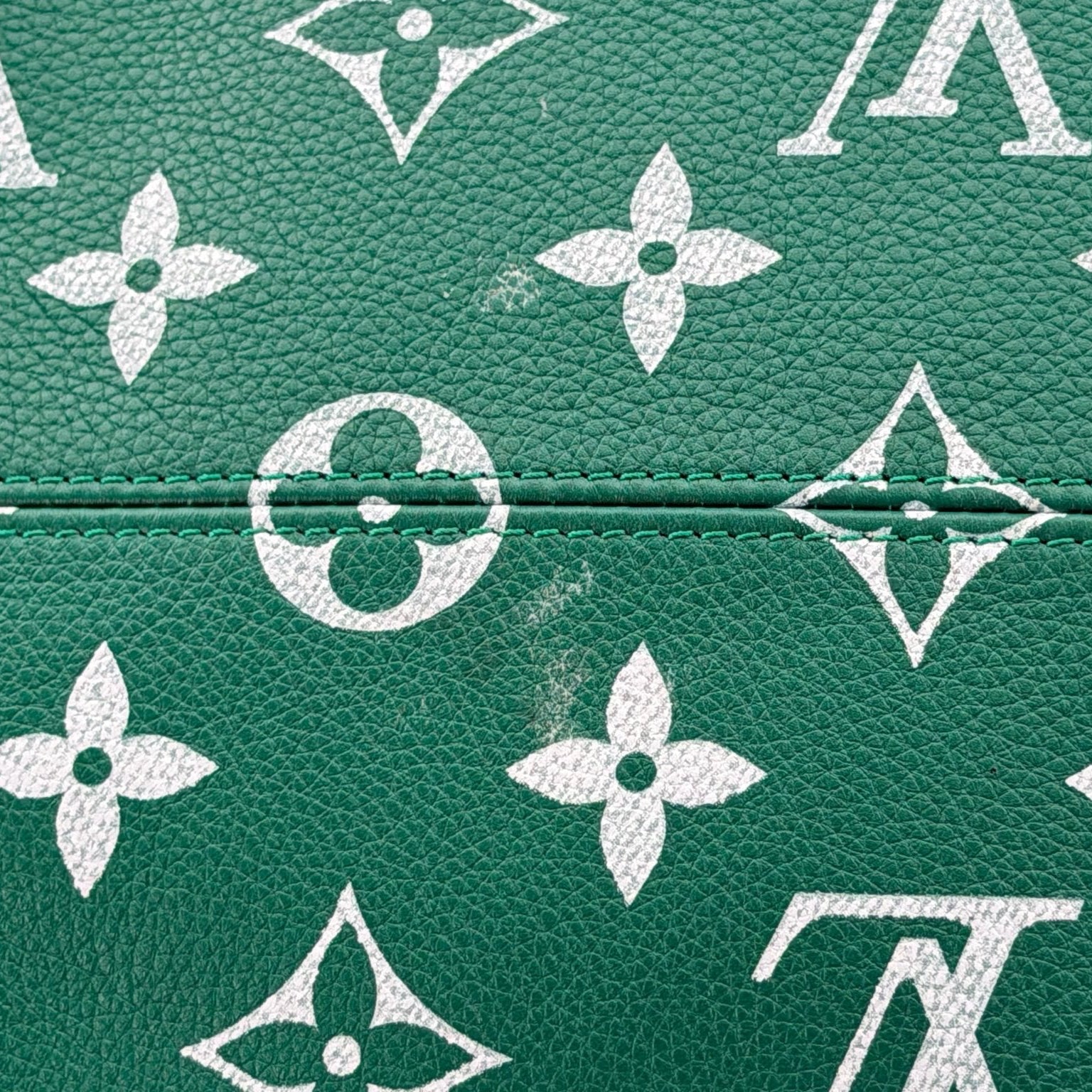 Louis Vuitton Speedy 950 travel bag in leather with gold hardware, featuring structured shape and signature monogram design.