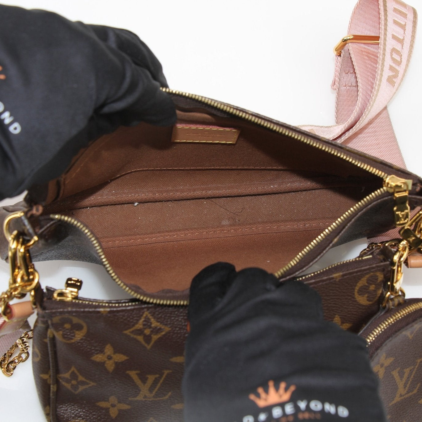 Louis Vuitton Multi Pochette handbag with gold accents, featuring multiple zippered compartments and a stylish design.