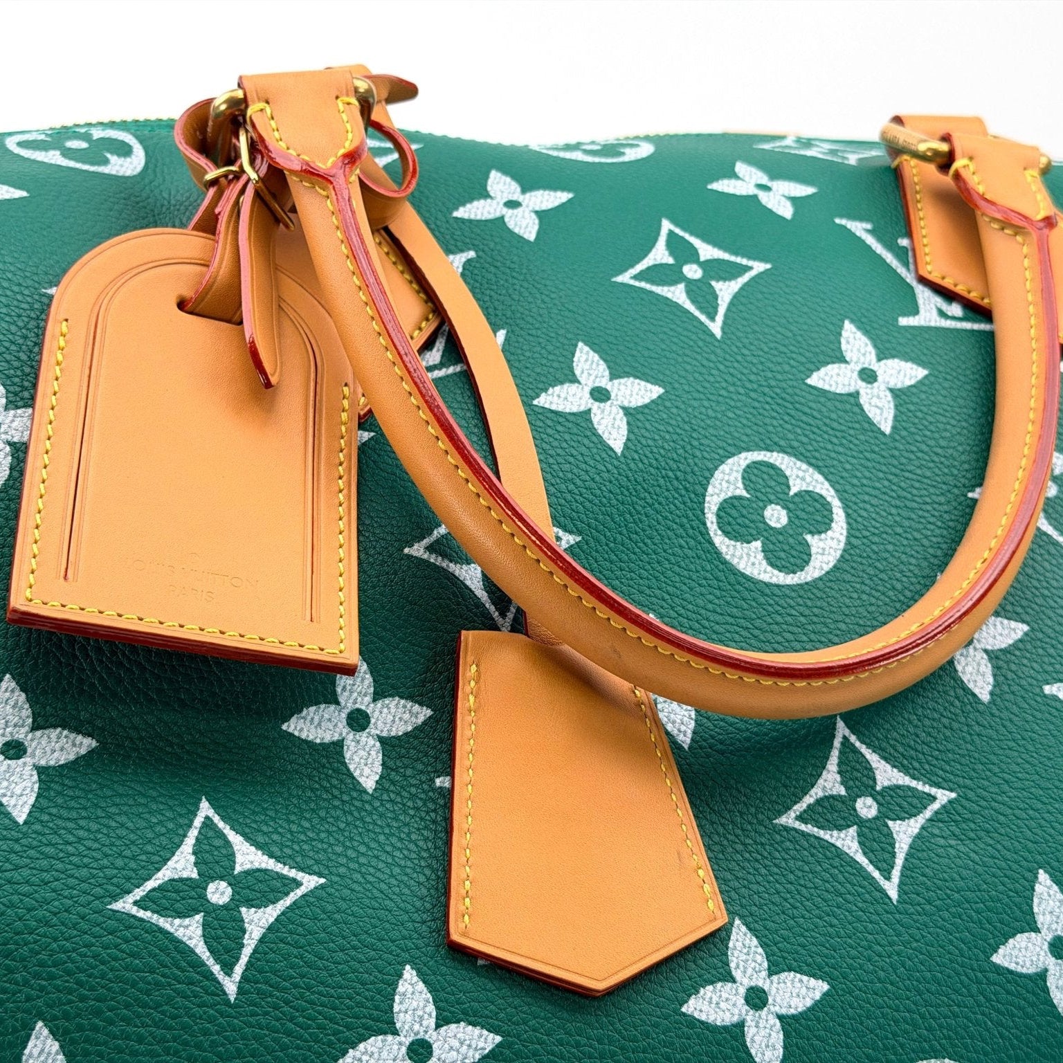 Gold & Beyond Louis Vuitton Speedy 950 travel bag with monogram canvas, leather handles, and gold-tone hardware.