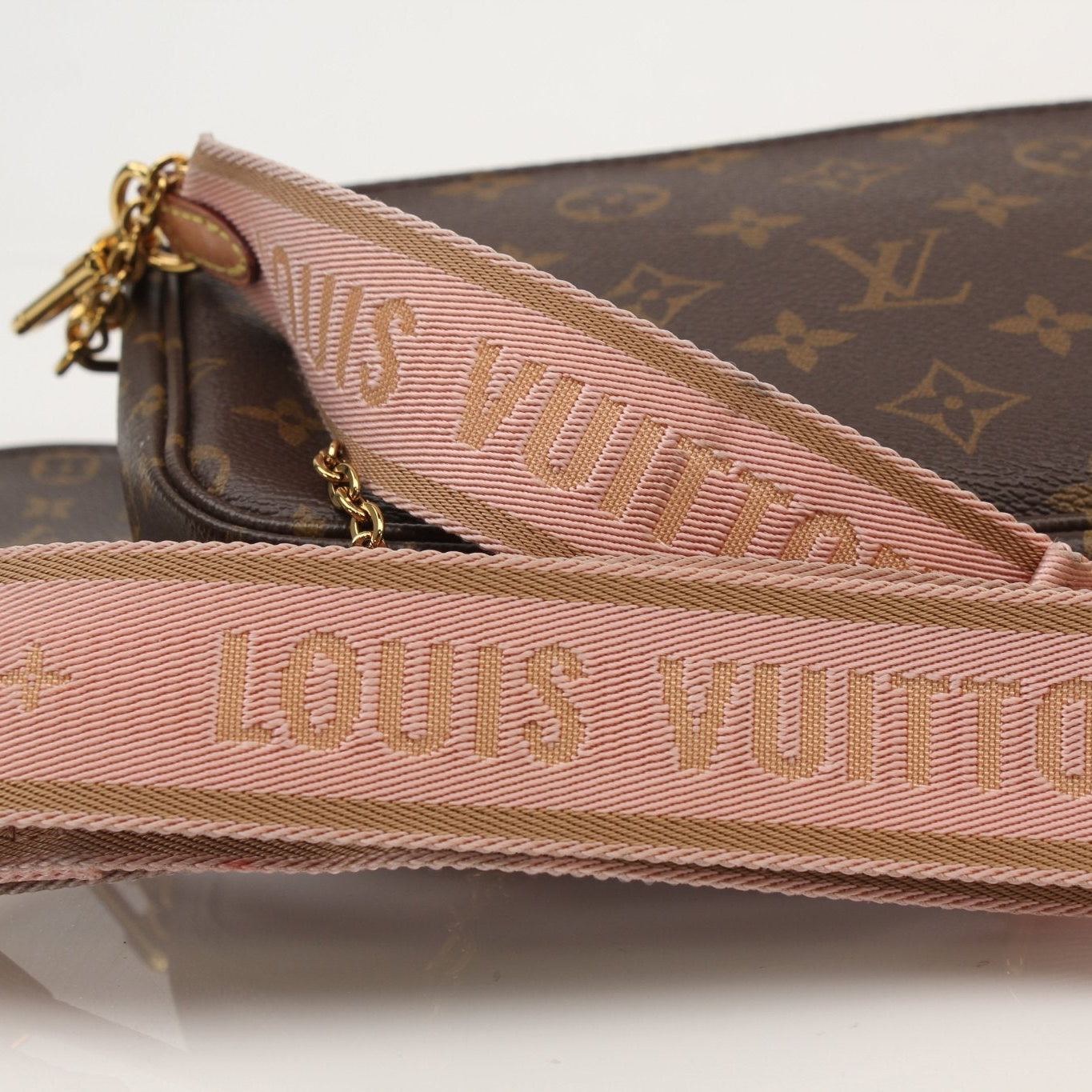 Louis Vuitton Multi Pochette handbag with gold hardware, featuring multiple compartments and a stylish design.