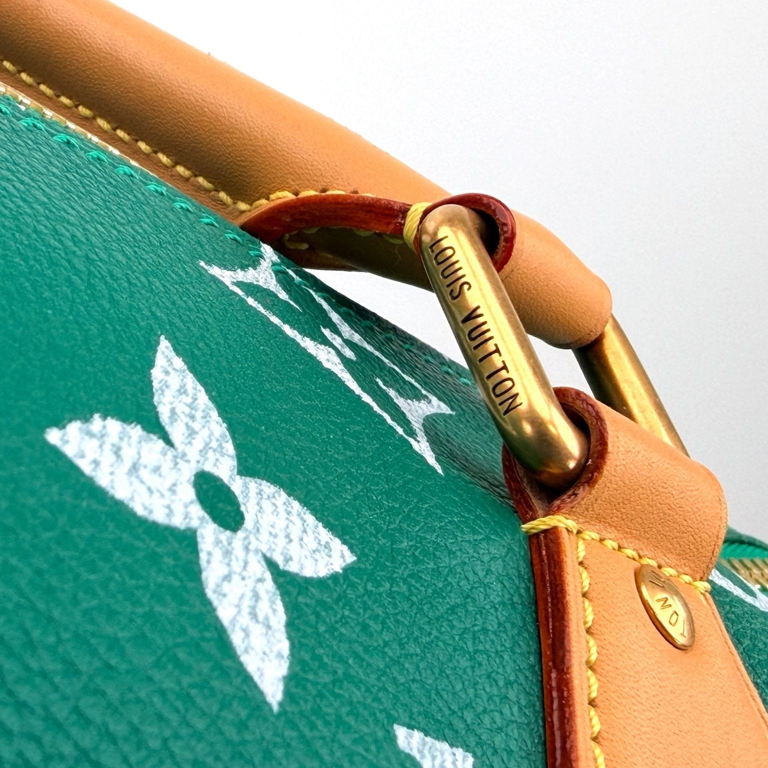 Gold & Beyond Louis Vuitton Speedy 950 travel bag with classic monogram canvas and leather handles, stylish and spacious for travel.