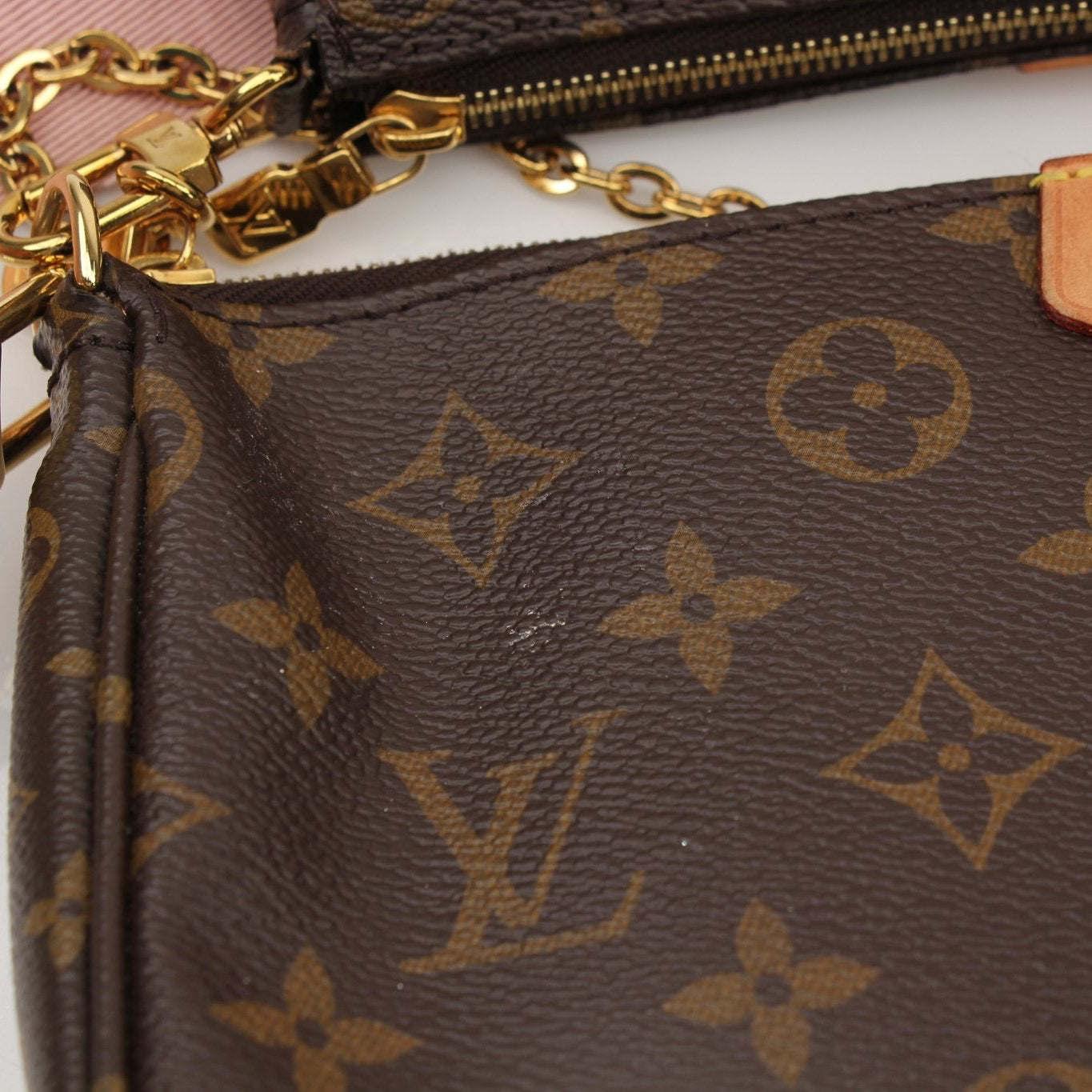 Louis Vuitton Multi Pochette handbag with gold accents, featuring multiple compartments and stylish design by Gold & Beyond.