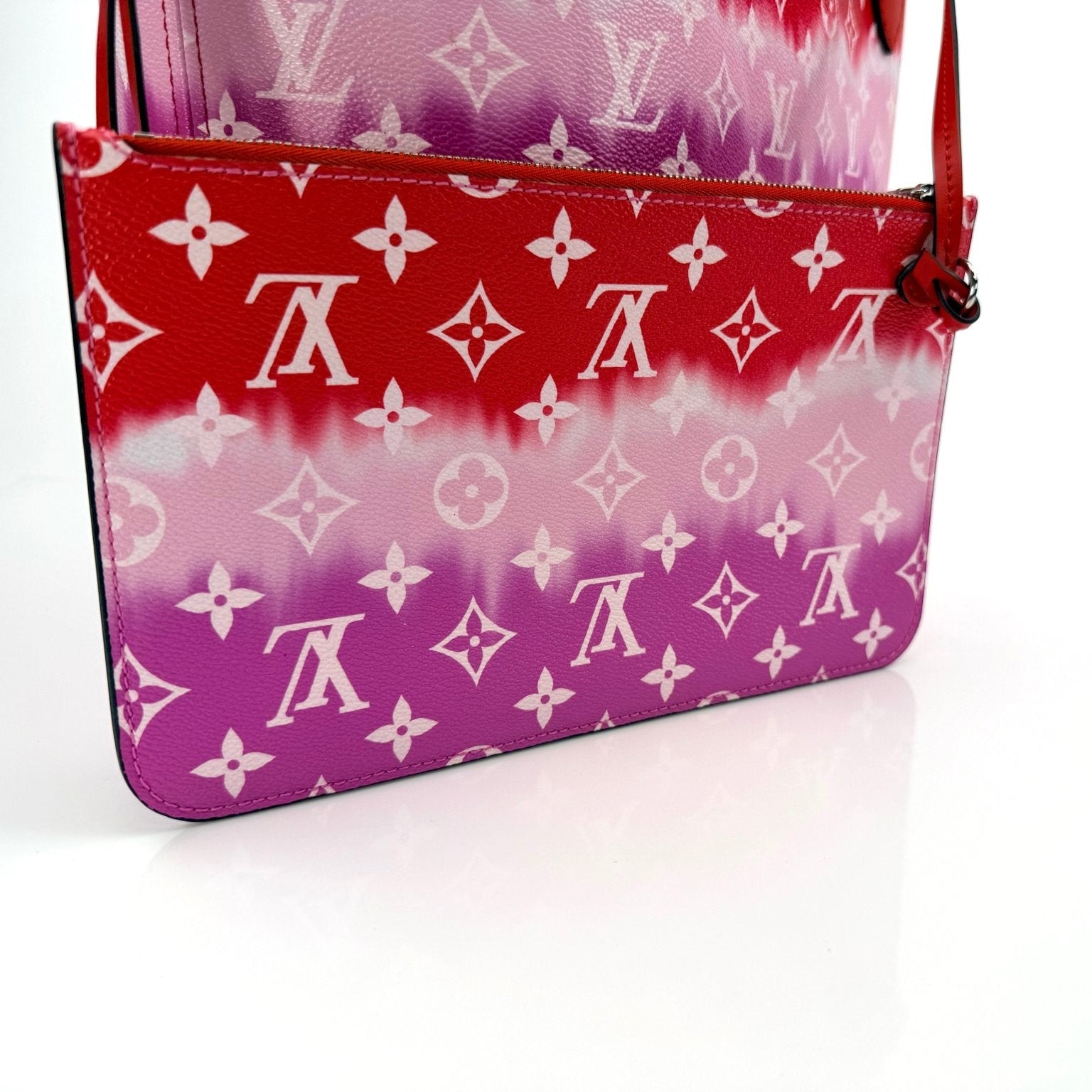 Louis Vuitton Neverfull Escale tote handbag with gold accents, featuring vibrant multicolor pattern and spacious interior.
