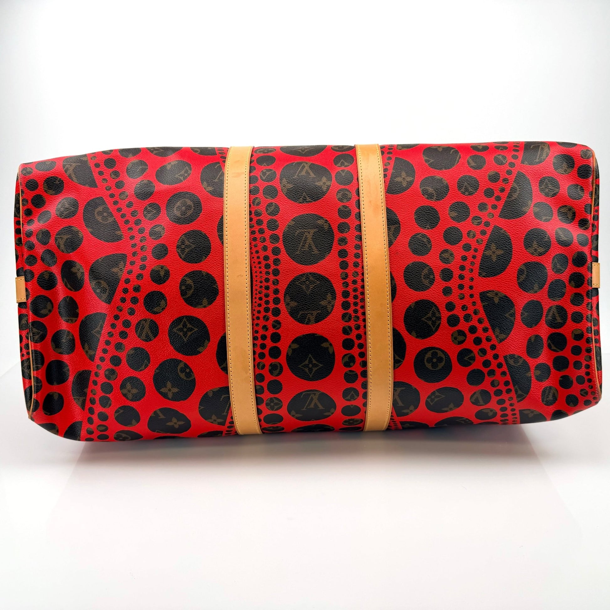 Louis Vuitton x Yayoi Kusama polka dot travel bag by Gold & Beyond, showcasing vibrant pattern and spacious design.