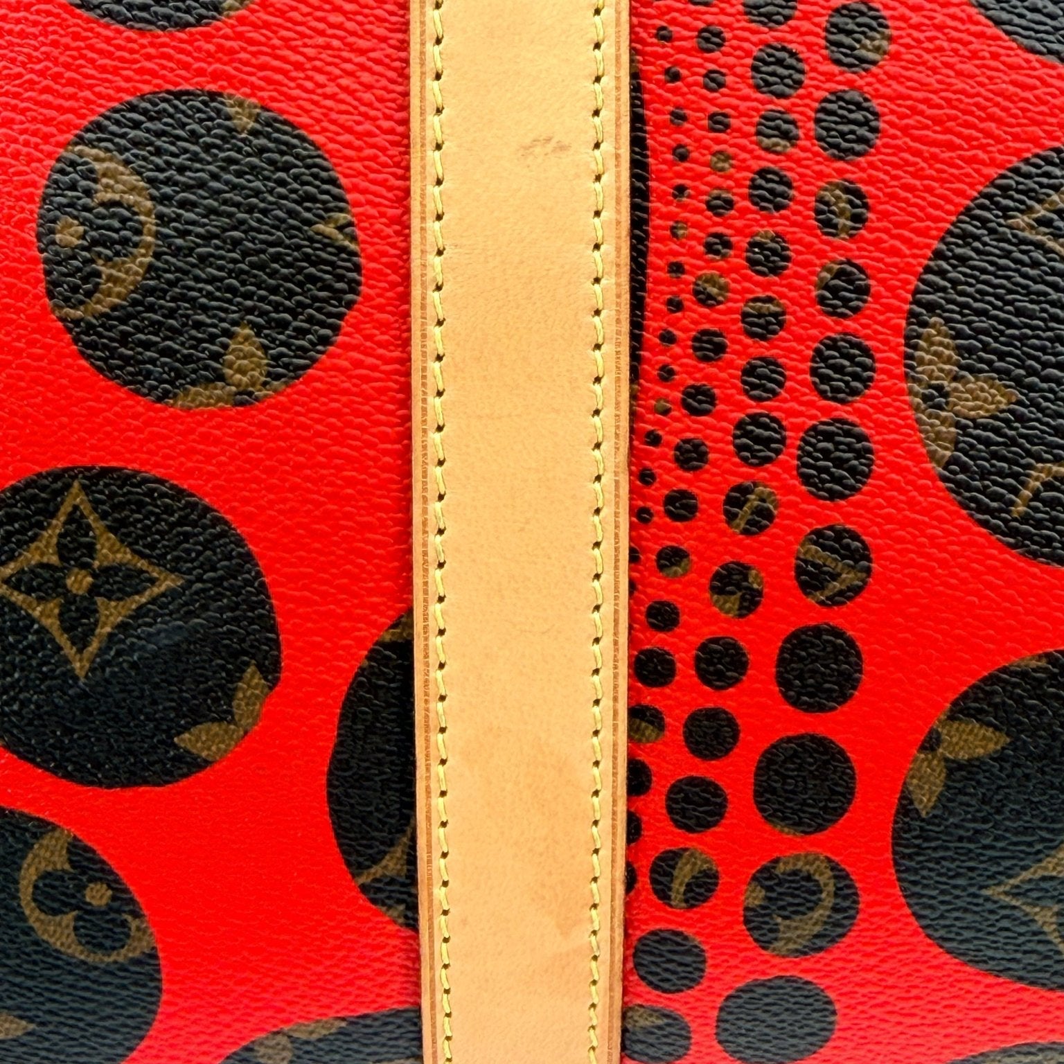 Louis Vuitton x Yayoi Kusama polka dot travel bag by Gold & Beyond, featuring bold black and white polka dot design and spacious interior.