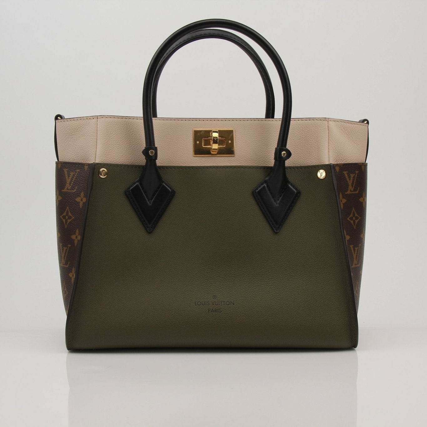 Louis Vuitton On My Side MM handbag in beige and brown canvas with leather accents, featuring gold-tone hardware and top handles.