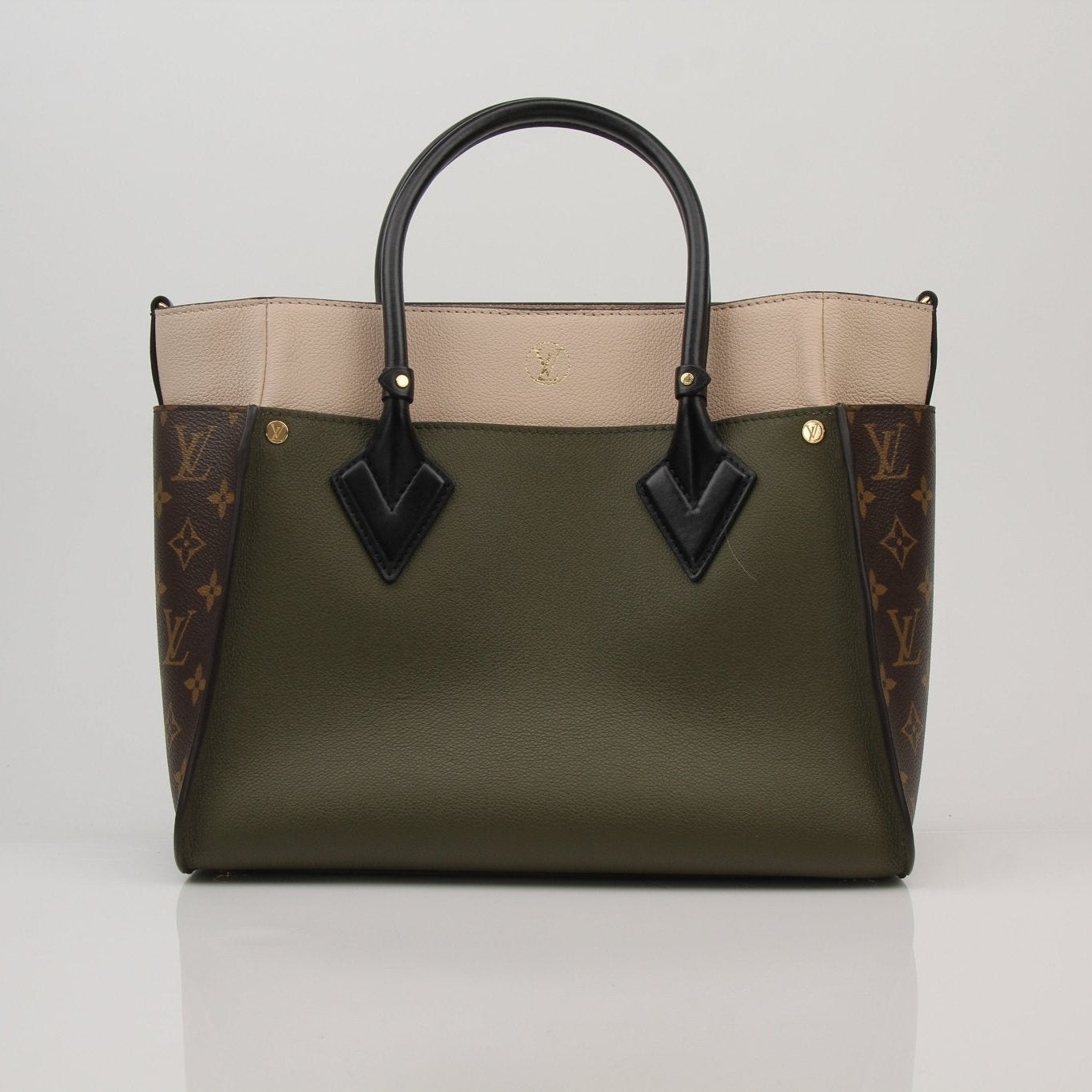 Louis Vuitton On My Side MM handbag with gold hardware and leather strap, displayed on a neutral background.