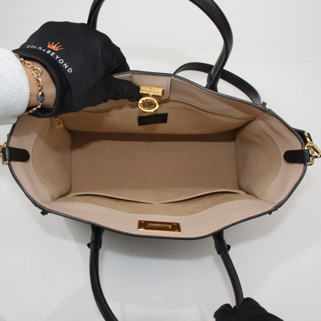 Louis Vuitton On My Side MM handbag in black leather with gold hardware, featuring a structured design and top handles.