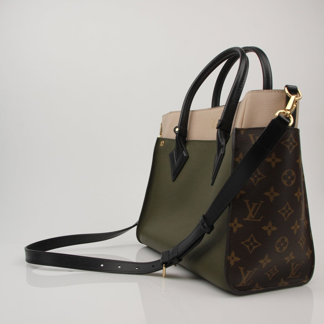 Louis Vuitton On My Side MM handbag in brown leather, featuring gold hardware and a top handle, displayed on a neutral background.