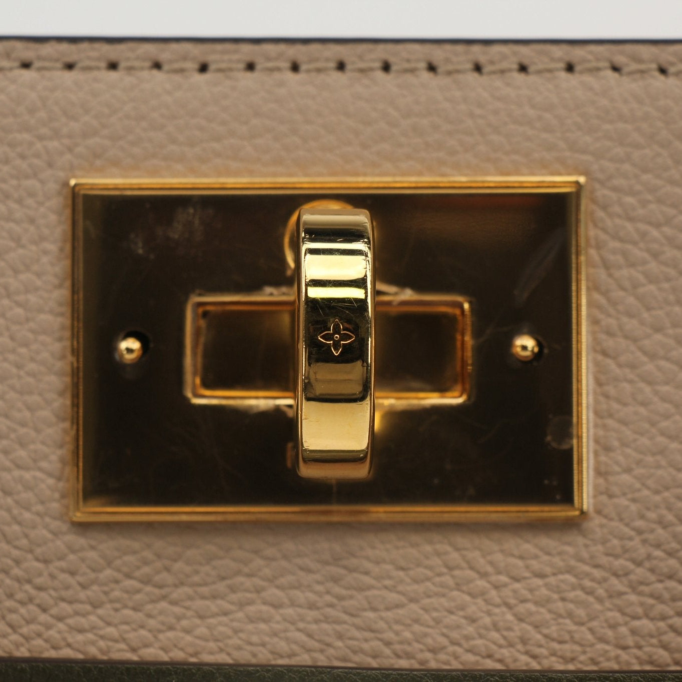 Louis Vuitton On My Side MM handbag in black leather with gold hardware, featuring dual top handles and signature LV detailing.