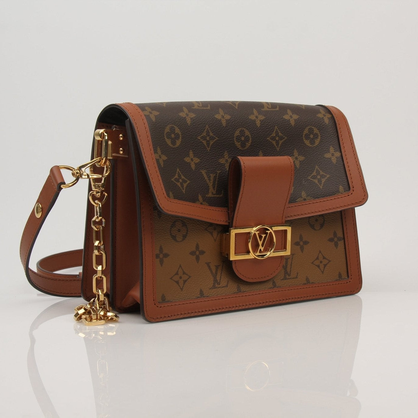 Louis Vuitton Dauphine MM handbag with gold hardware, featuring structured leather design, shown in a close-up image.